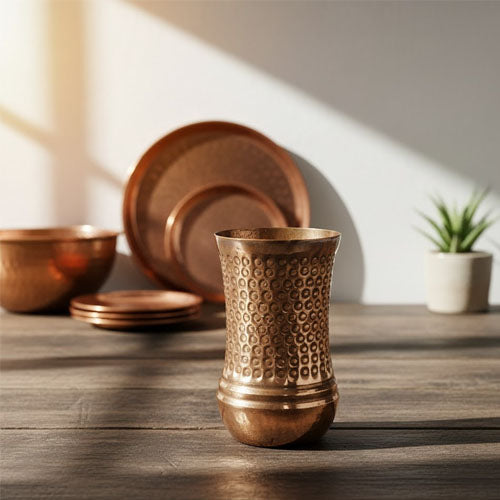 A beautiful, tall copper tumbler featuring an intricate hammered pattern